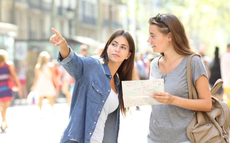 Lost tourist asking for help from a pedestrian in the street